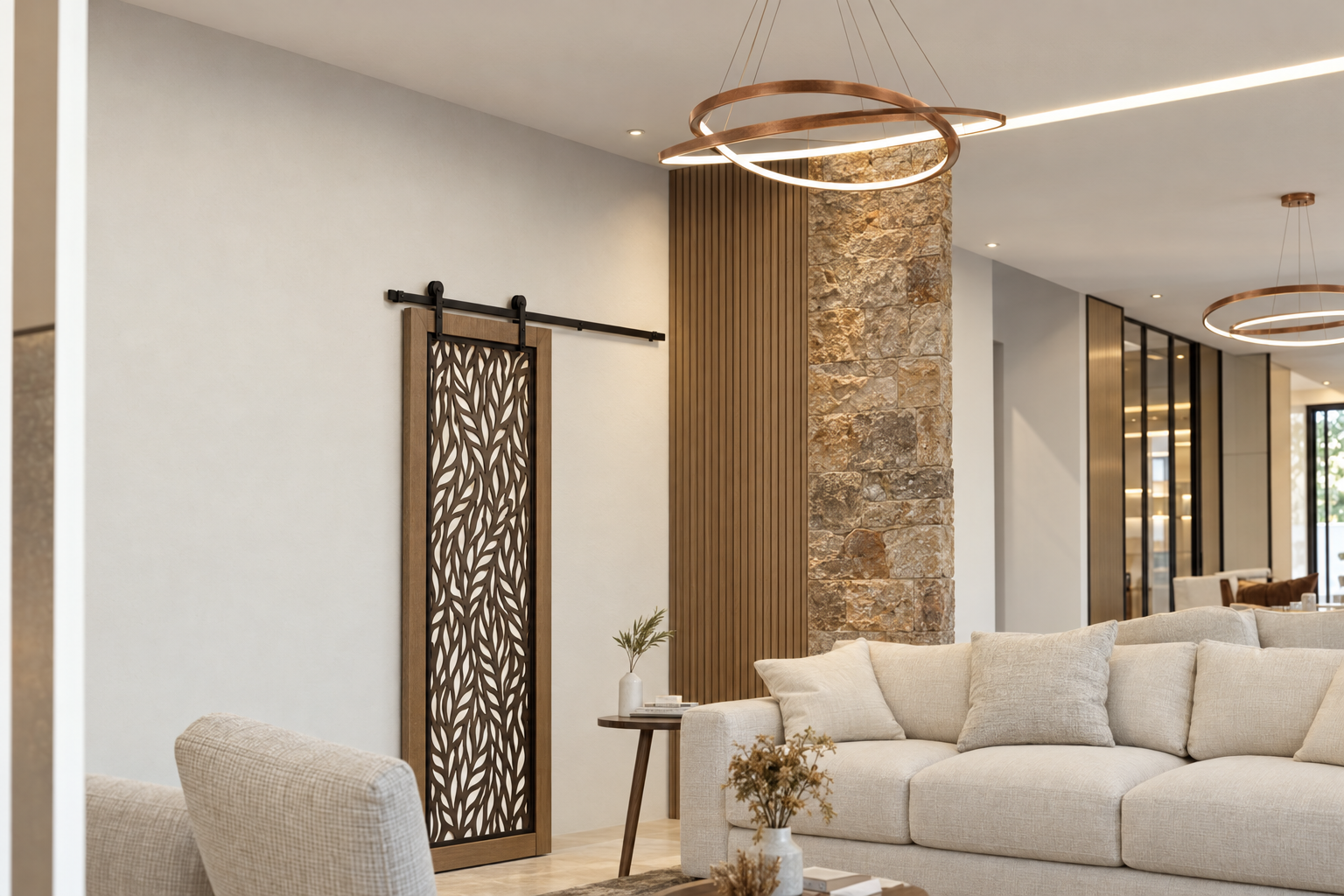 Living room with stone feature wall, ring pendant light and decorative timber screen in a Satori Villas townhouse